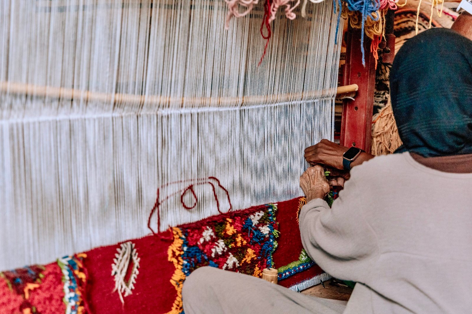 Taznakht,Morocco, 15 October 2023 A skilled artisan meticulously weaves a vibrant Moroccan rug on a traditional loom. The intricate patterns and rich colors of the rug.
